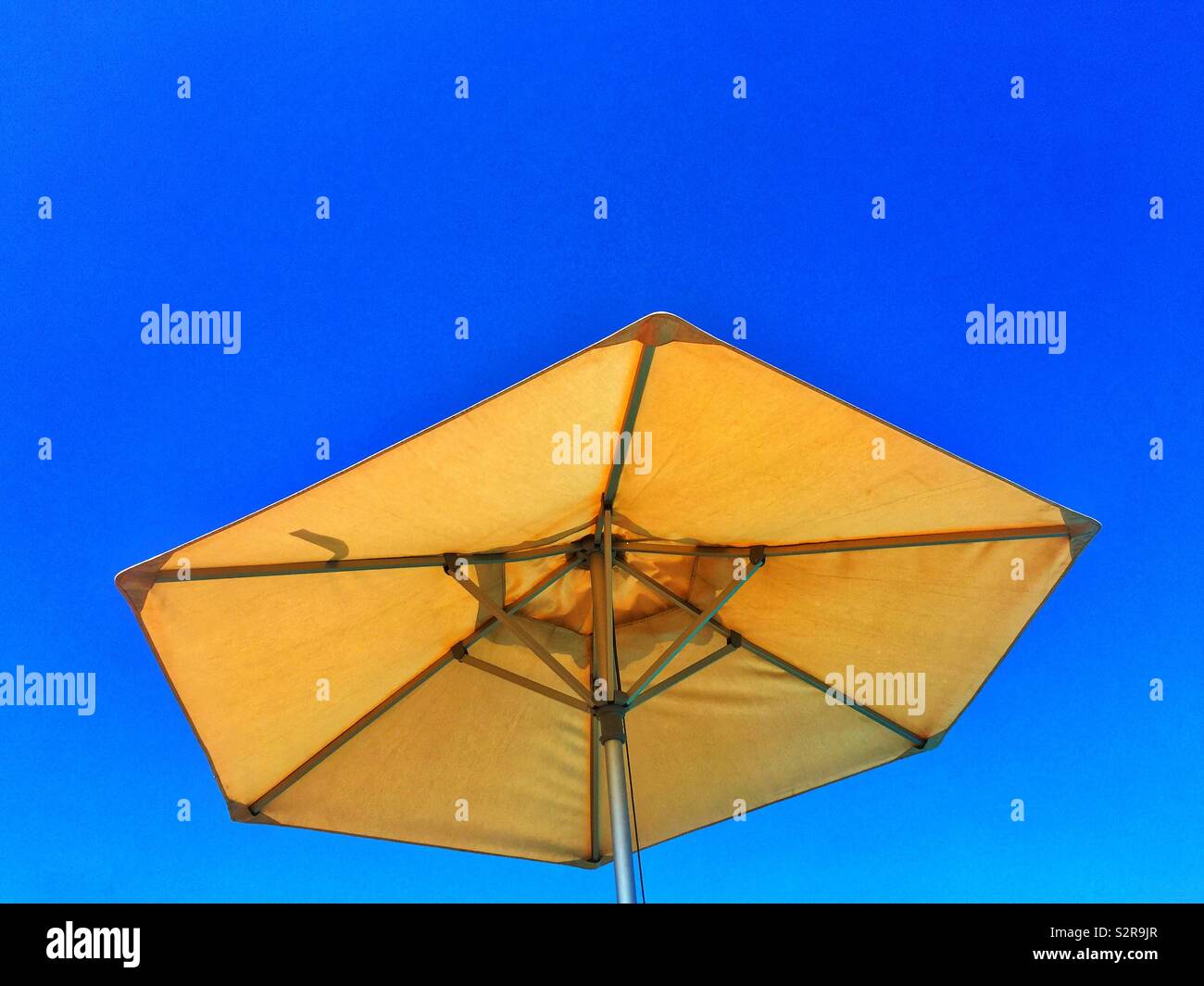 Beach umbrella against blue sky - Smartphone Captured Stock Image