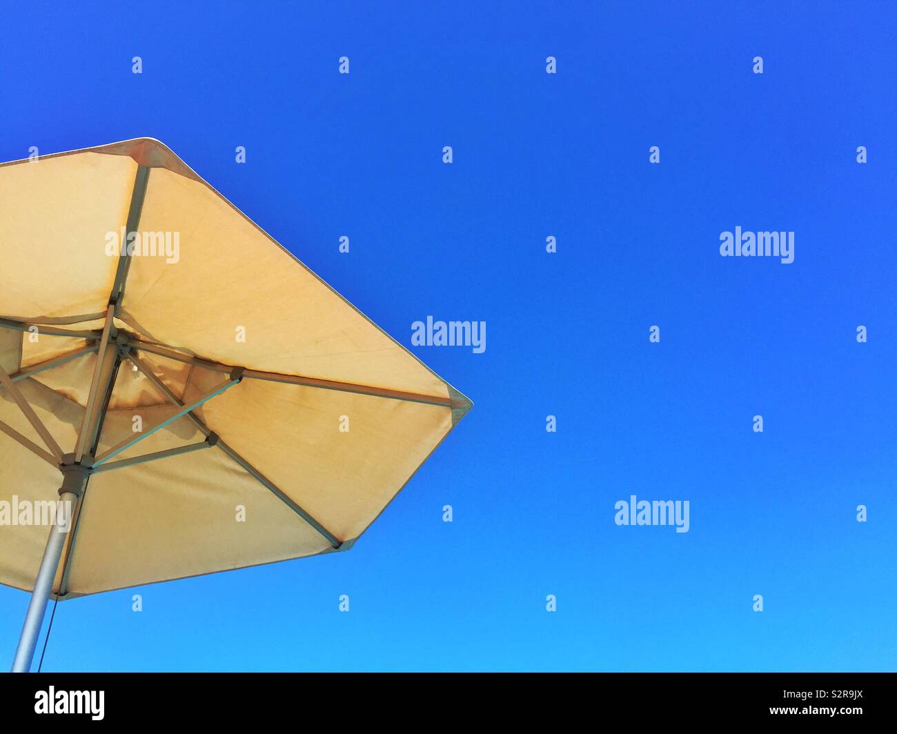 Beach umbrella against blue sky Stock Photo