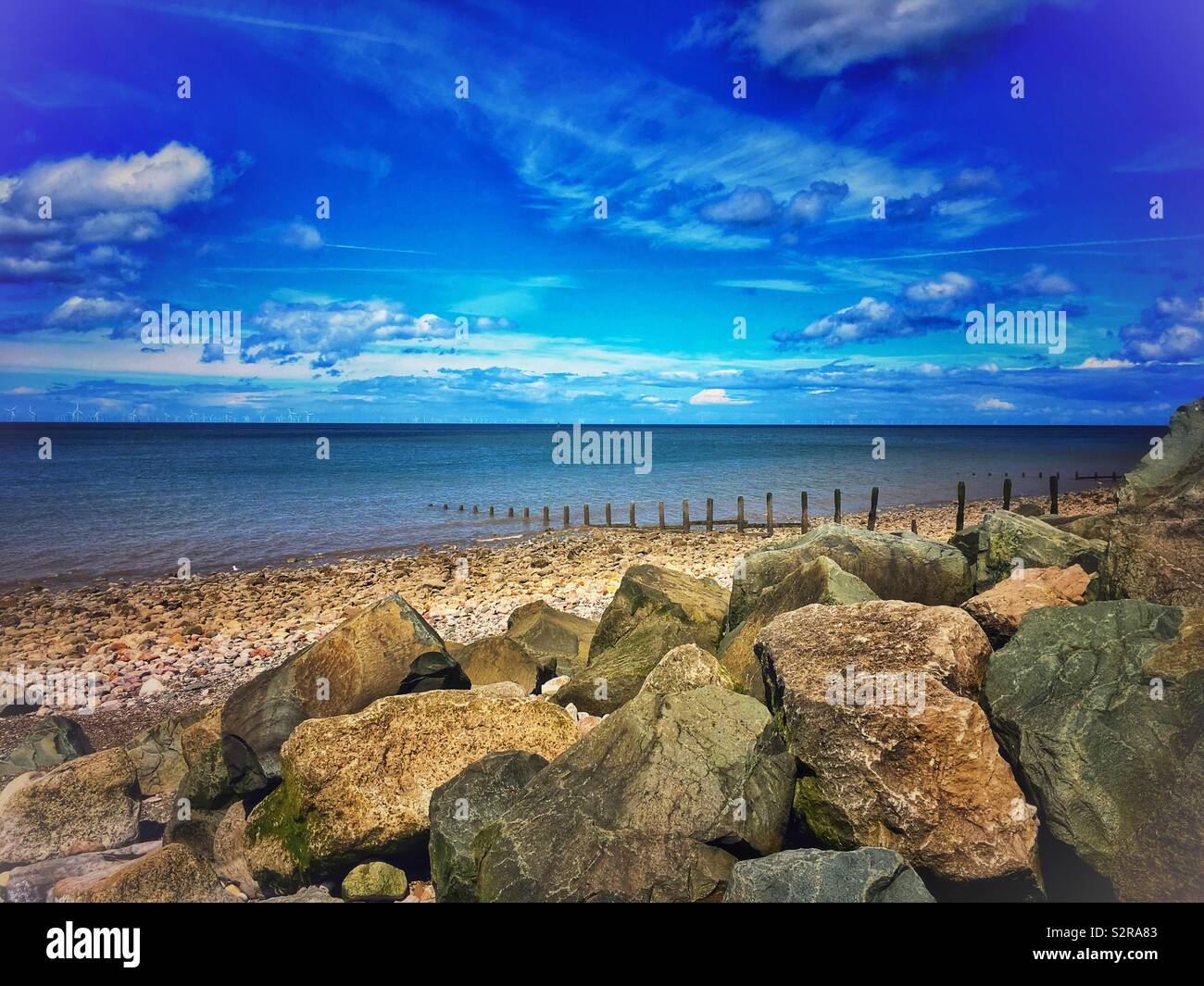 Pebbled beach with boulders in North Wales Uk - Smartphone Captured Stock Image