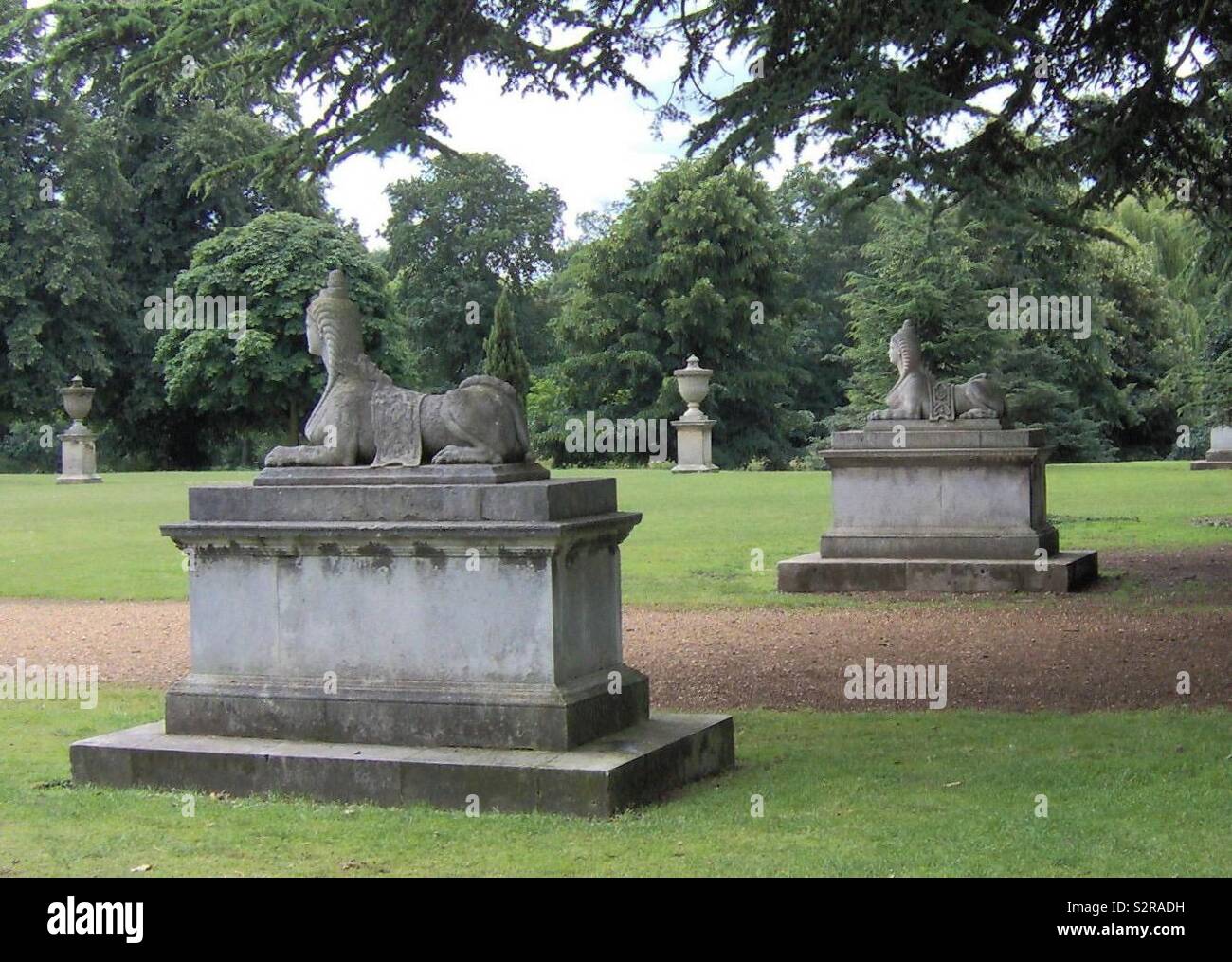 A pair of Sphinx mounted on plinths in Chiswick Park London - Smartphone Captured Stock Image