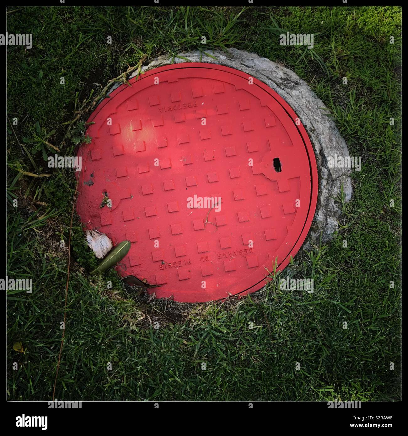 Red drain cover. Stock Photo