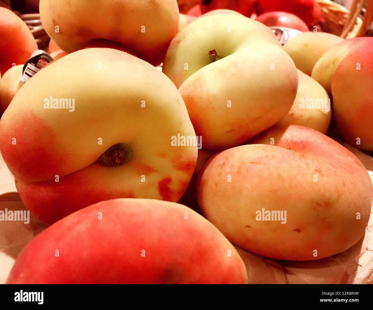Donut peaches for sale in a grocery store display, United States Stock
