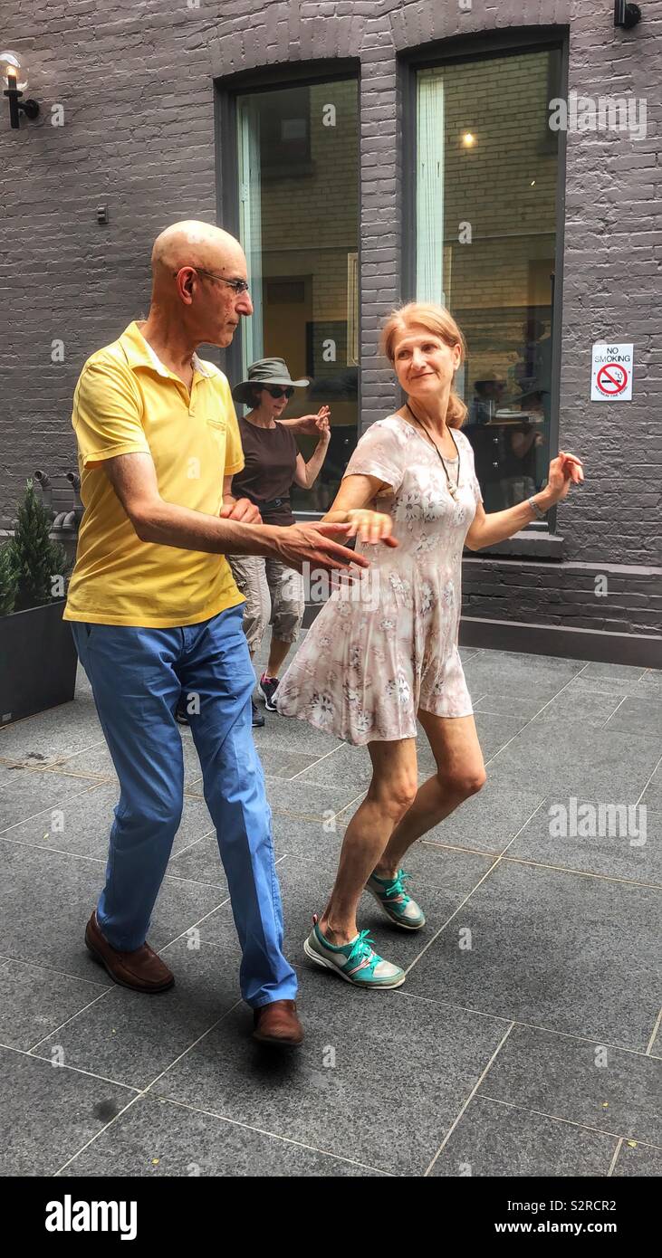 Swing dancers enjoying the afternoon at an outdoor music festival. - Smartphone Captured Stock Image