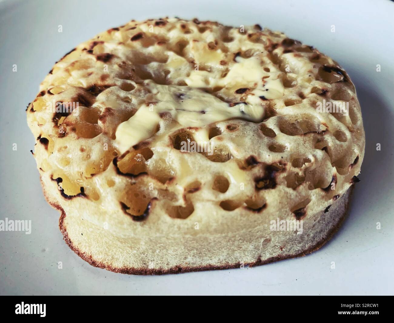 Crumpet with butter Stock Photo