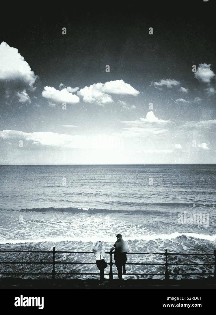 Young couple looking out at the ocean - Smartphone Captured Stock Image