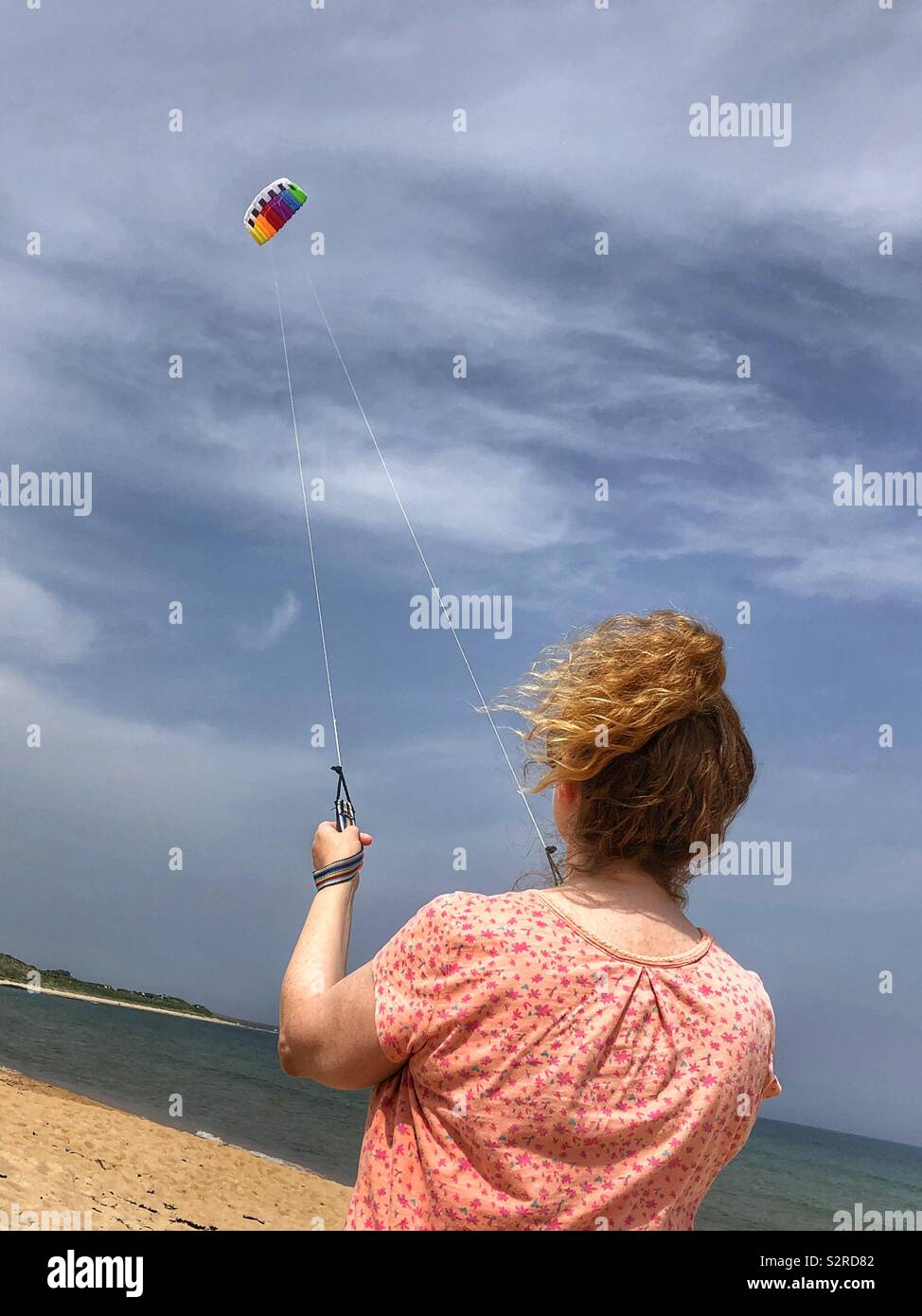 Woman on the beach with stunt kite hi-res stock photography and images ...