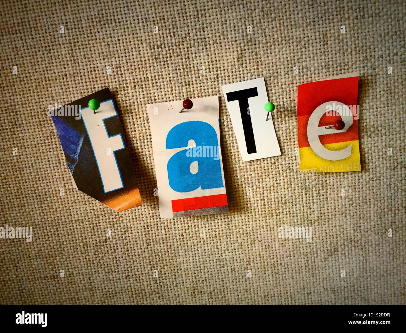 The word fate on a bulletin board with cut out paper letters using ransom note effect typography, USA Stock Photo