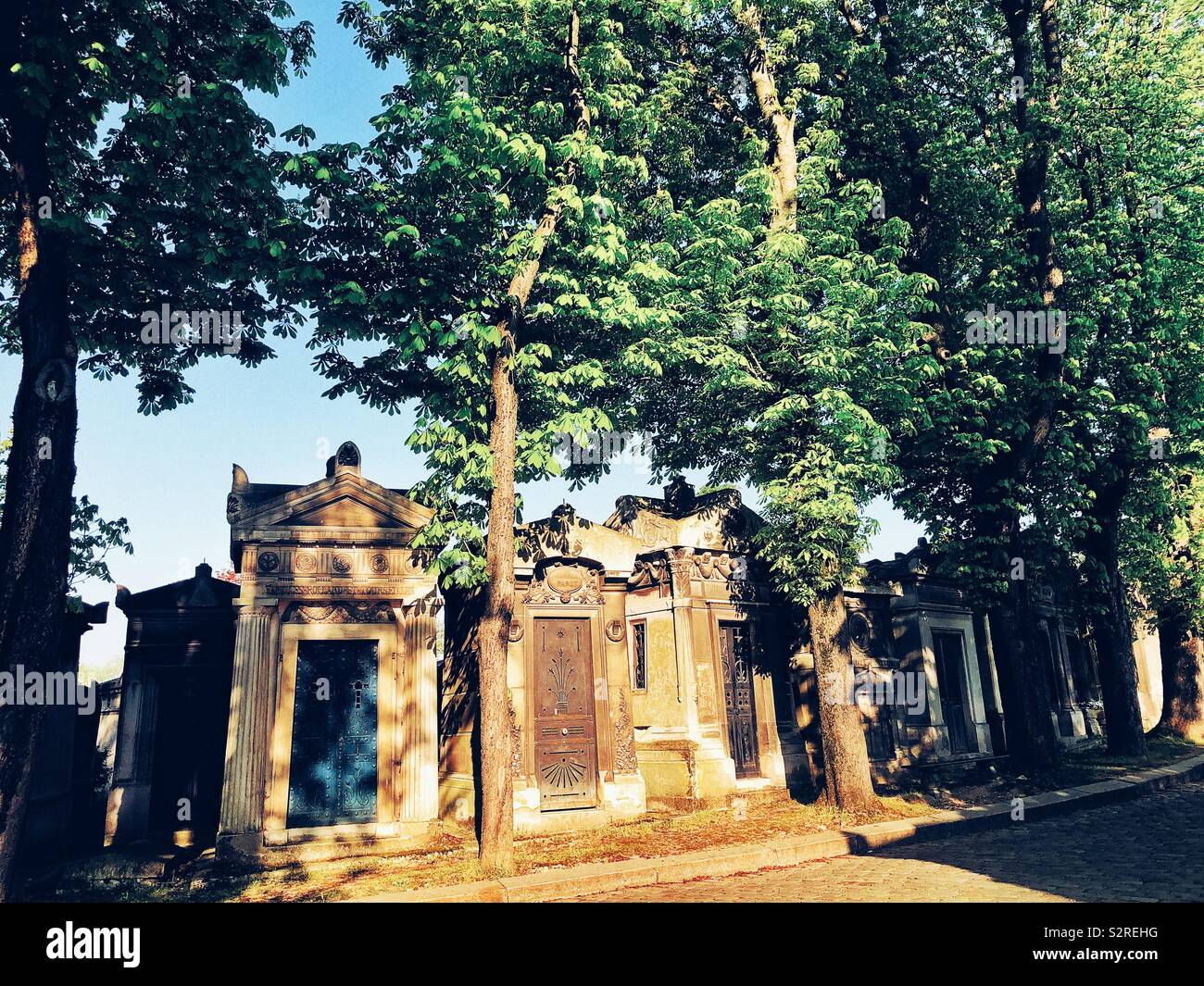 Sun shining on the tombstones at the Père Lachaise public and nondenominational cemetery in Paris Stock Photo