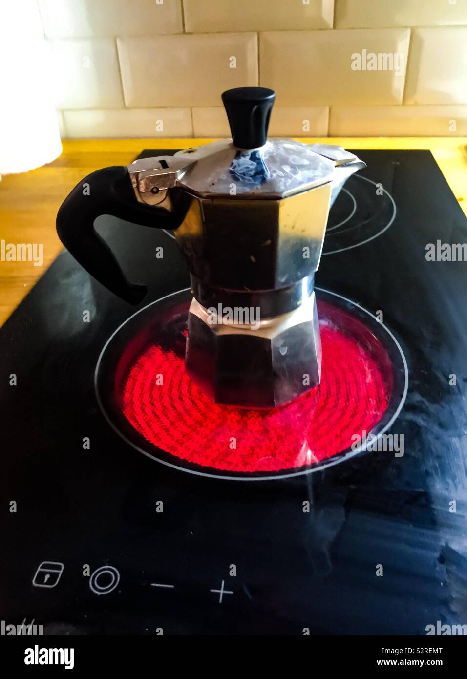Red hot espresso maker. Concept, morning routine - Smartphone Captured Stock Image