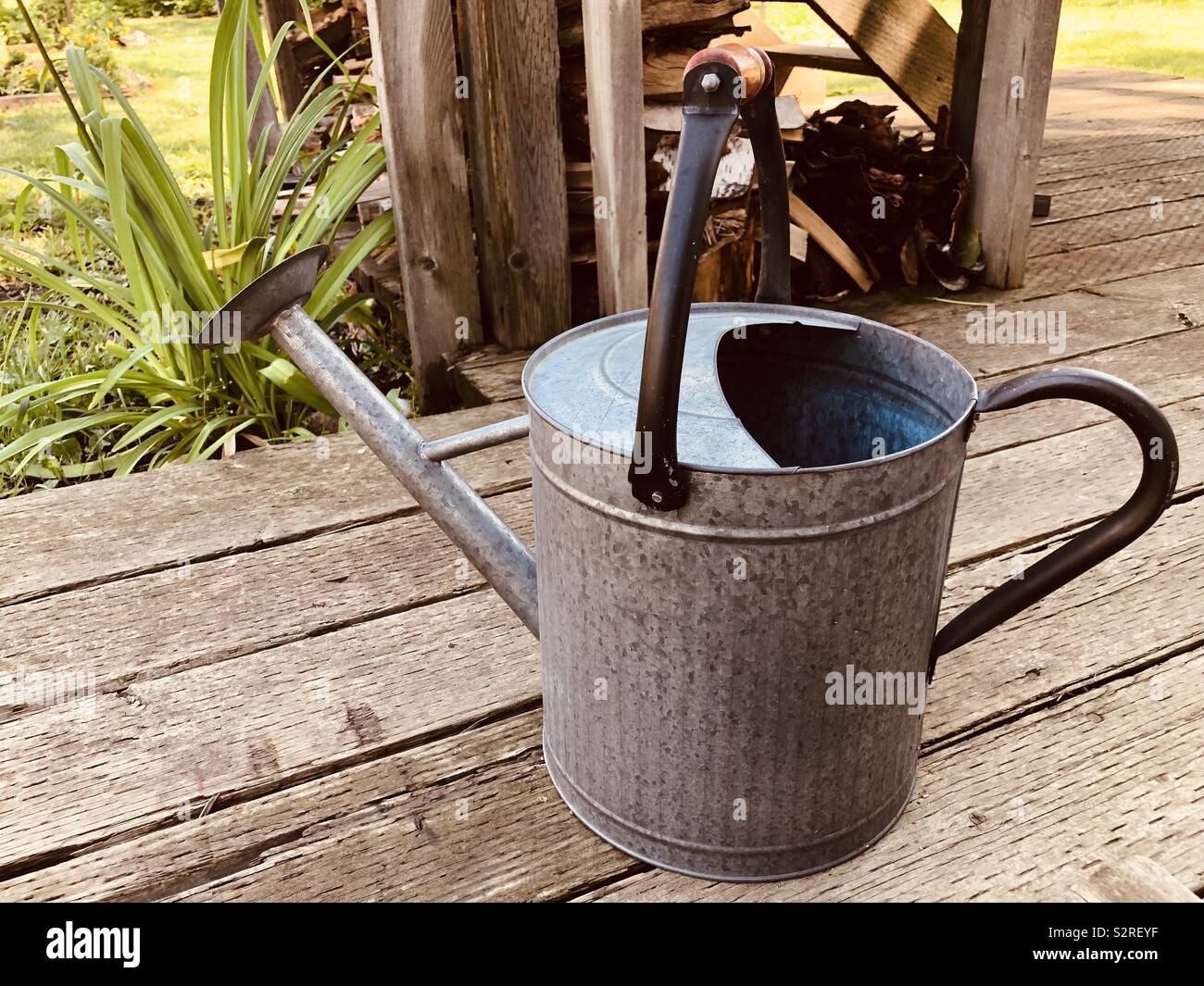 Vintage tin watering can on the homestead Stock Photo