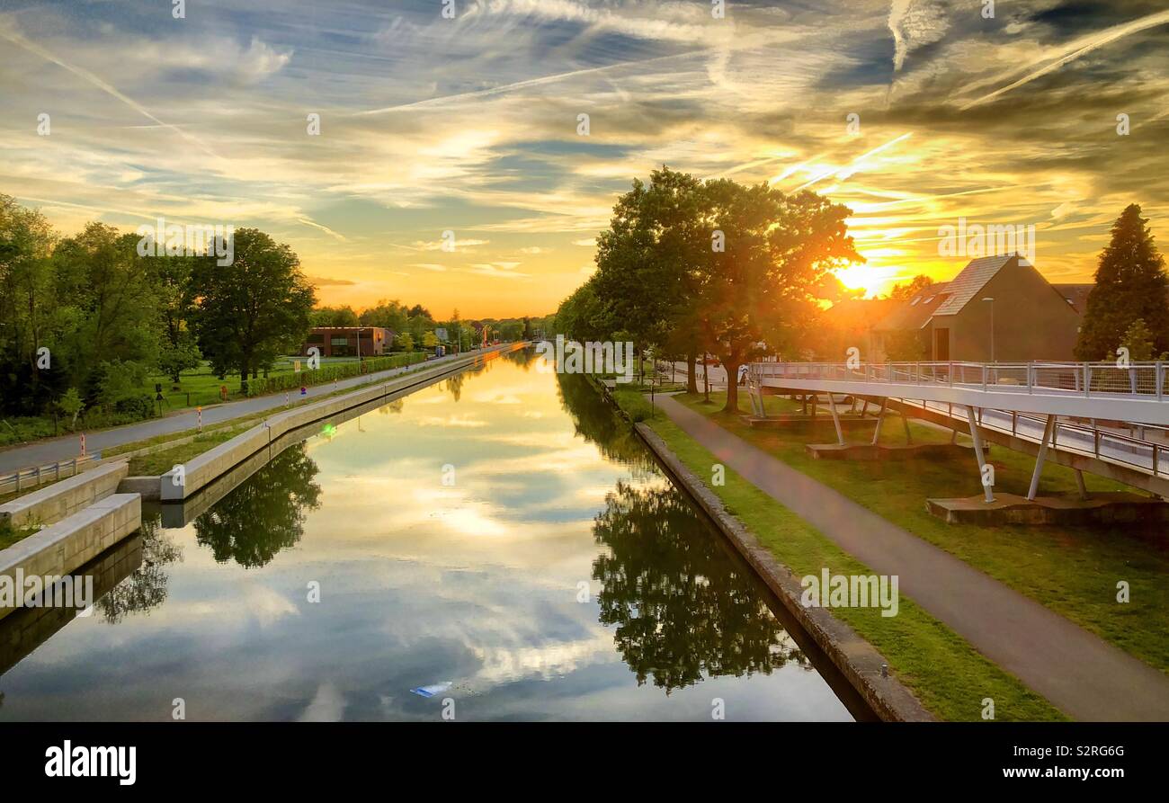 Colorful and dramatic sunset over the canal reflected in the water - Smartphone Captured Stock Image