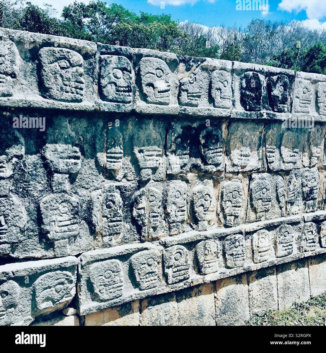 Mayan stone faces on wall Stock Photo Alamy