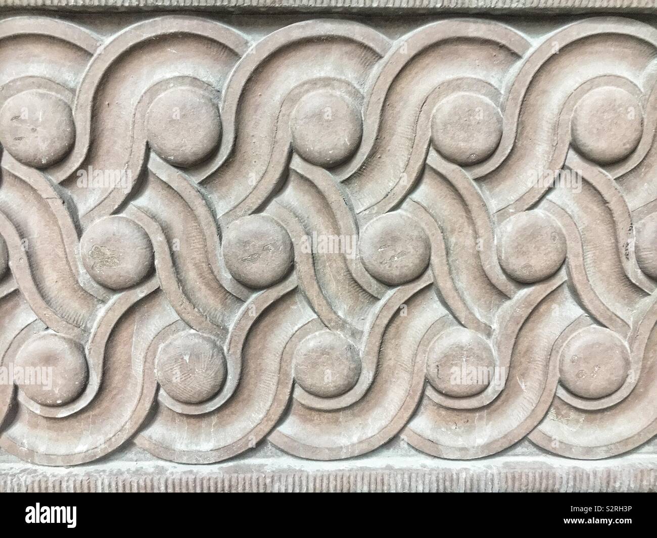 Concrete architectural detail of scrolls and circles in a repeating pattern. Stock Photo