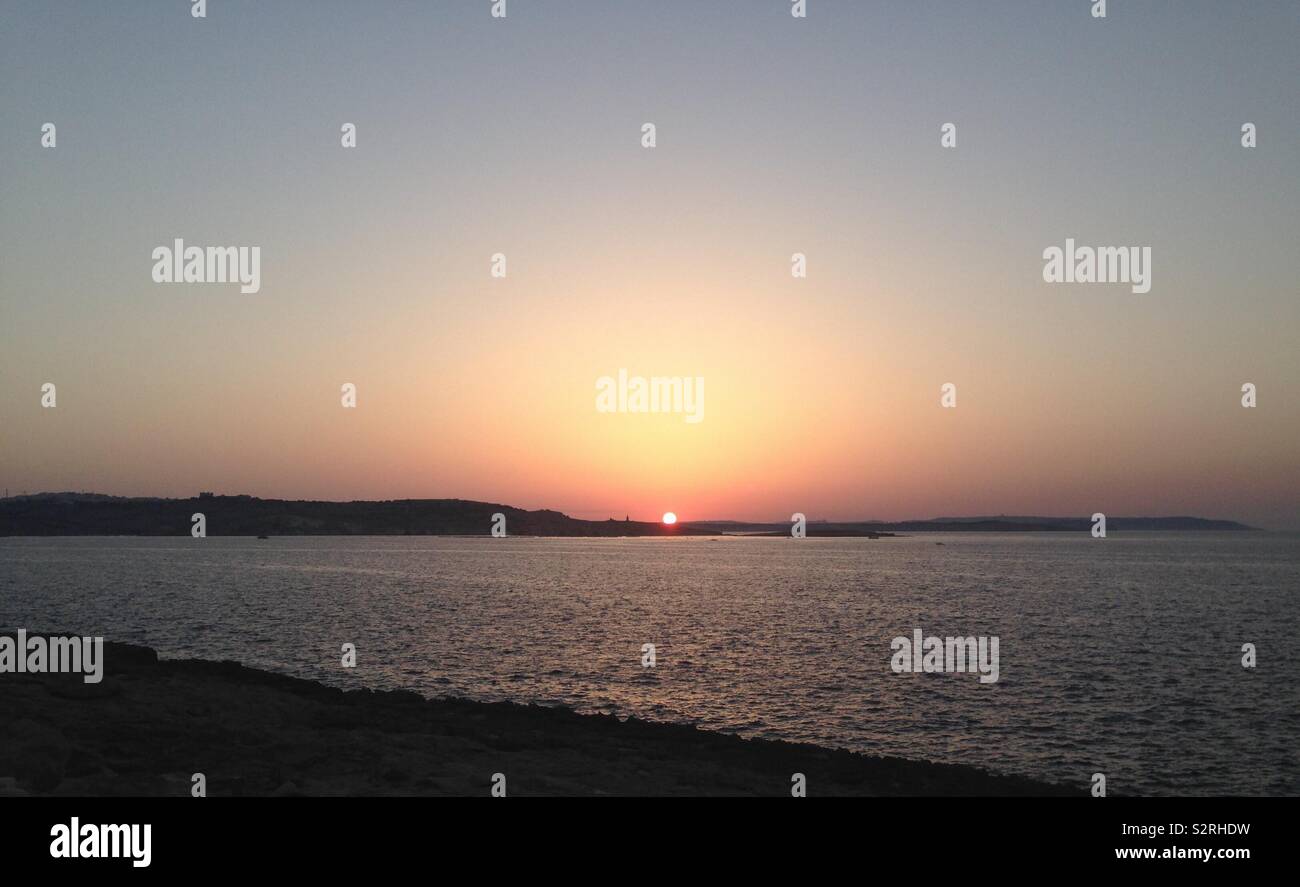 The impressive view of the last seconds of sunshine. Taken on Malta Stock Photo
