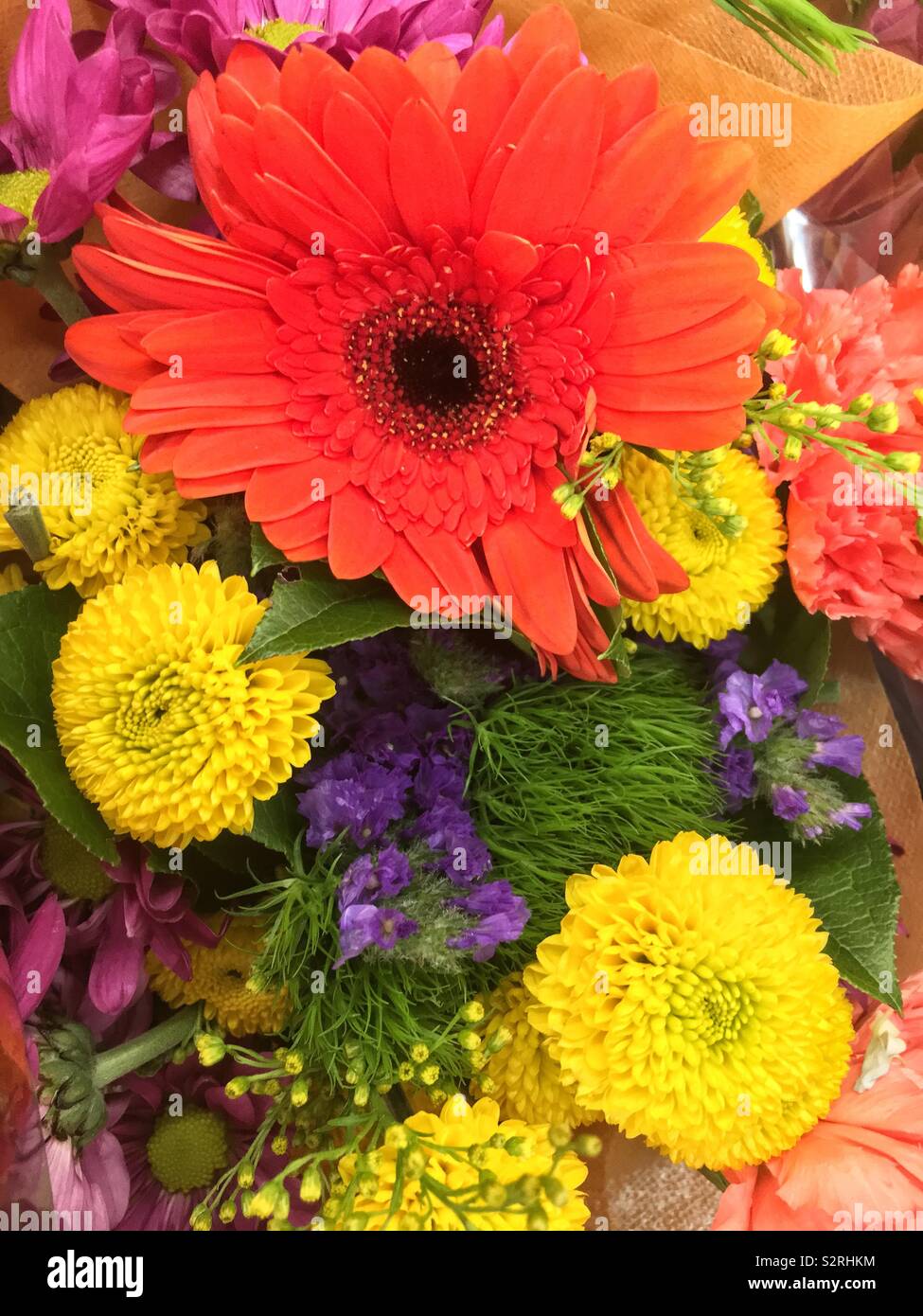 Fragrant bouquet of colorful summer blossoms including a bright daisy and yellow zinnias. Stock Photo