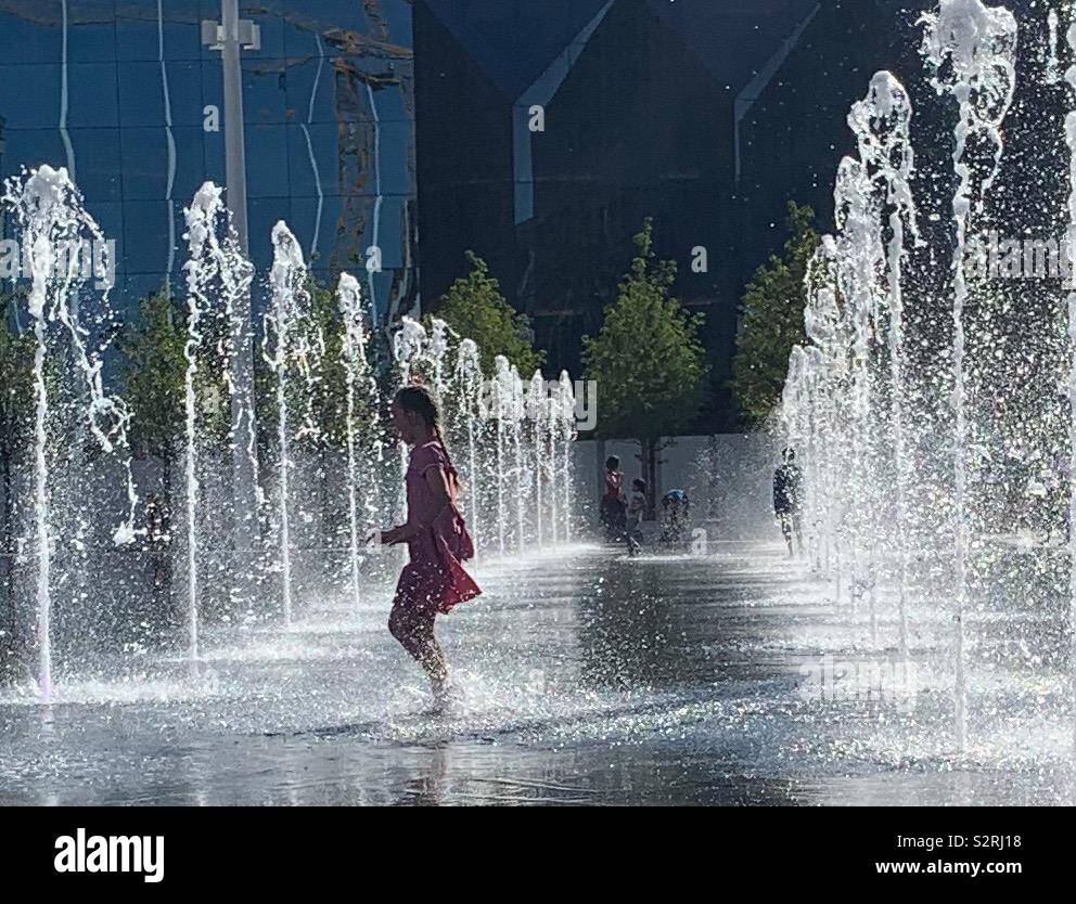 Child Playing in Fountain Stock Photo - Alamy