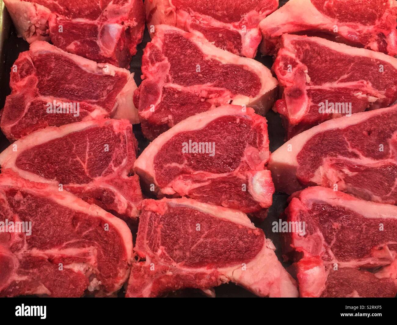 Selection of fresh lamb loin chops at the local butcher’s counter Stock