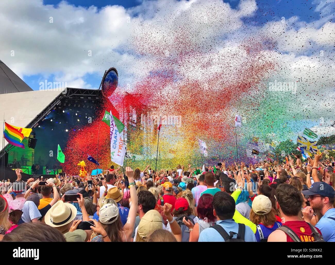 A cloud of rainbow coloured confetti over the crowd at the great set played by Years & Years at the Glastonbury Festival 2019 Stock Photo