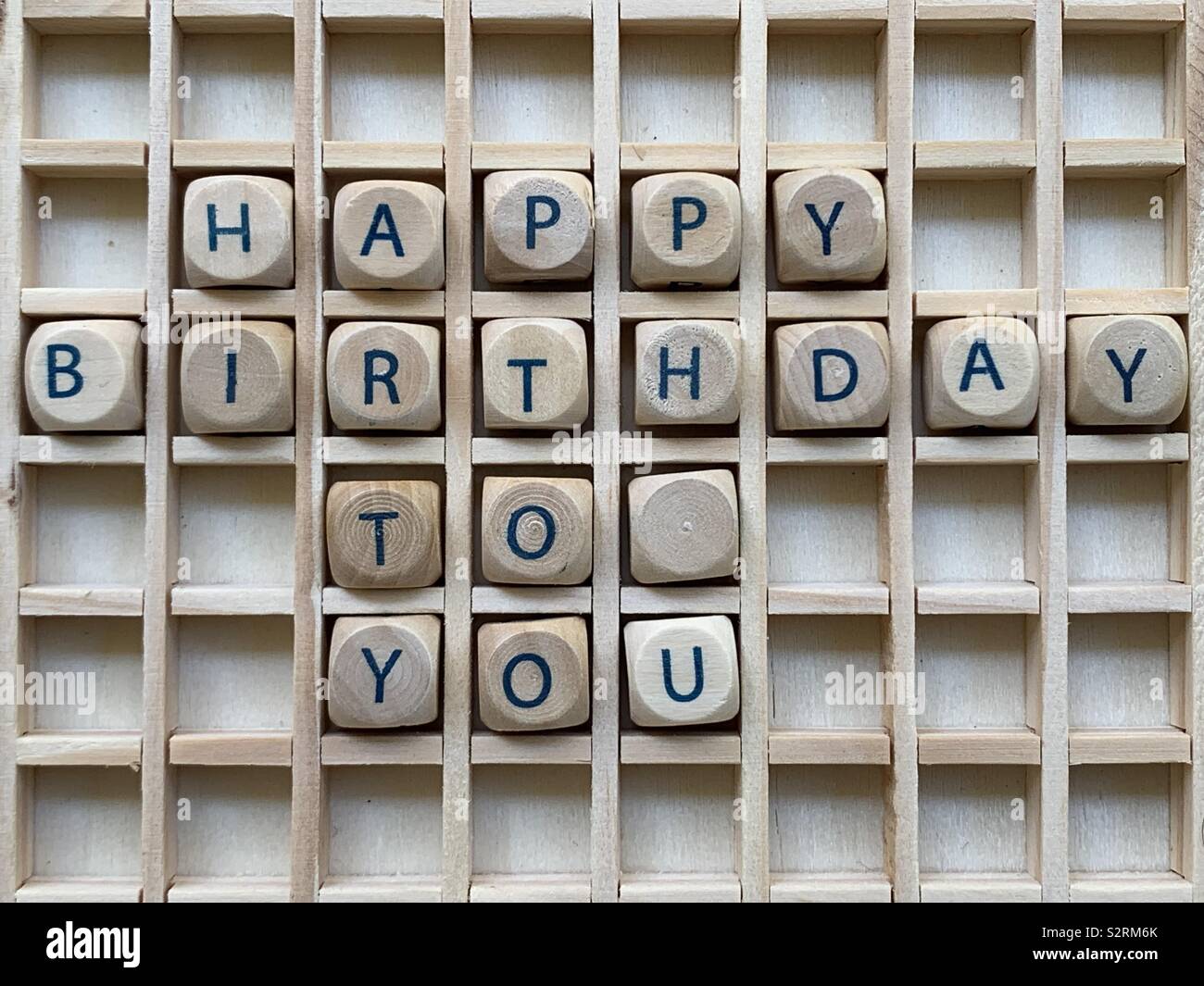 Happy Birthday to you text composed with wooden cube dice letters - Smartphone Captured Stock Image