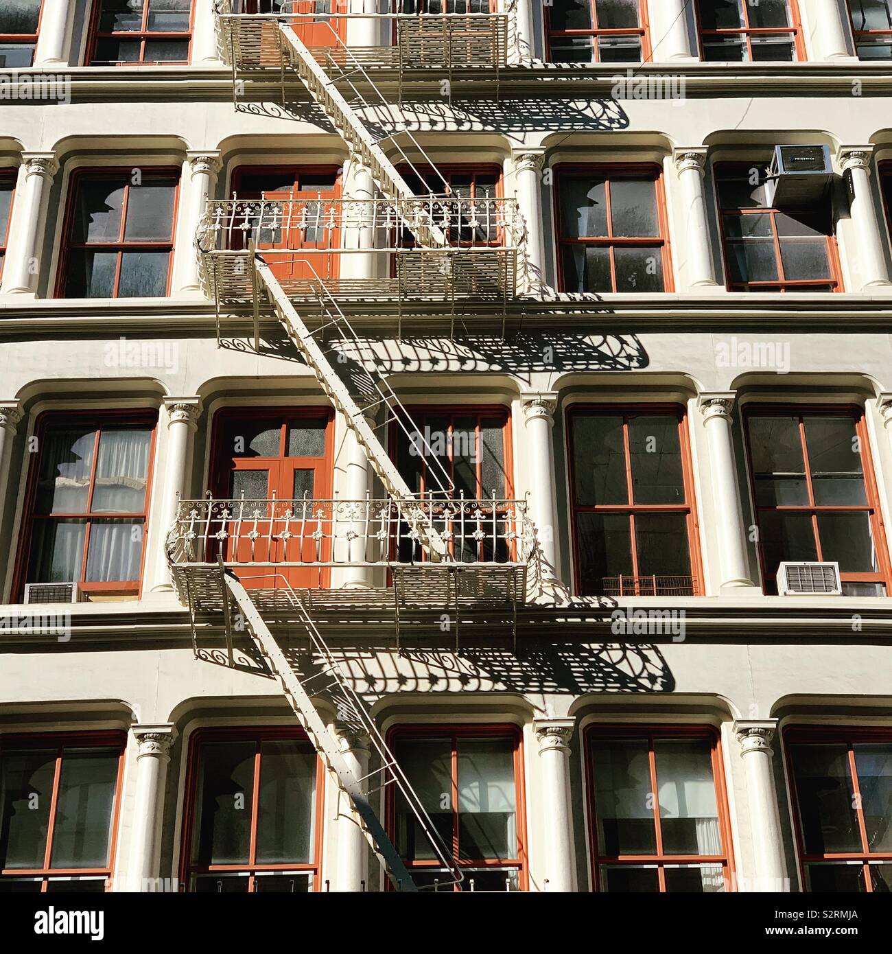 Windows Doors And Fire Escapes On A Cast Iron Building In