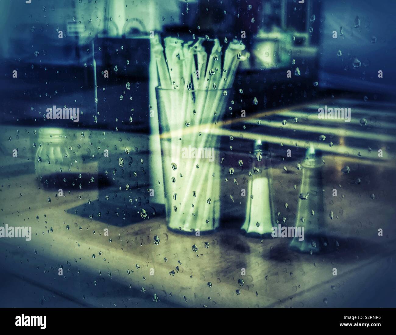 Looking in a raindrop covered restaurant window - Smartphone Captured Stock Image