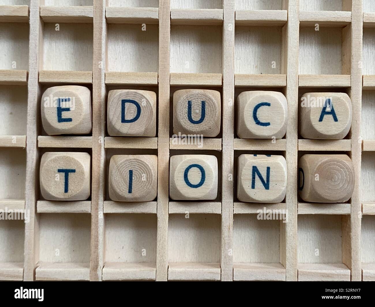 Education word composed with wooden cube dice letters Stock Photo