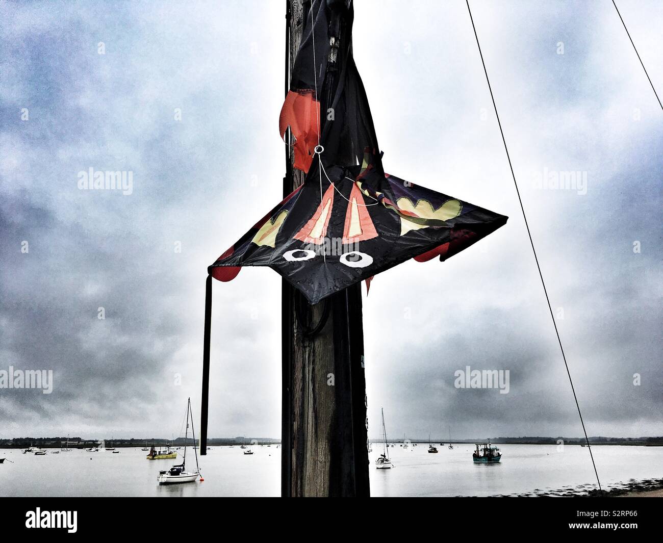 A kite wrapped around lamp post - Smartphone Captured Stock Image