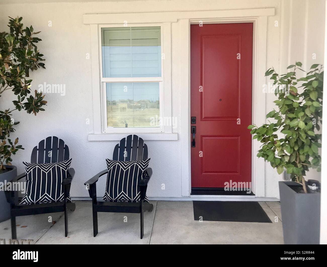 Beautiful Front Porch Patio Of A Home With Lawn Chairs Potted Plants And A Red Door Usa America Stock Photo Alamy