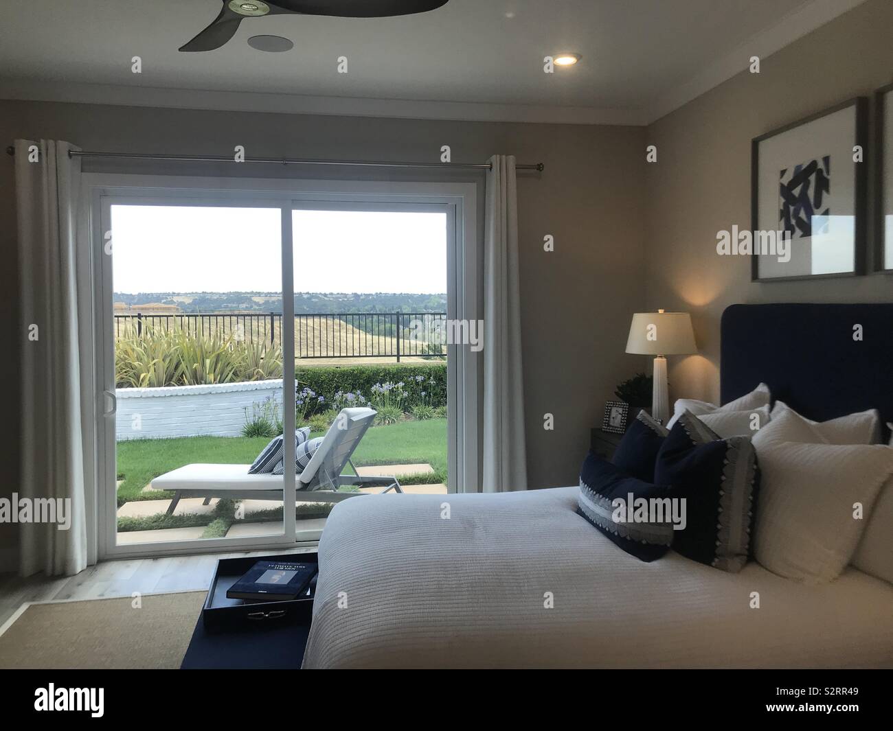 Relaxing And Calm Bedroom With A Large Sliding Glass Door