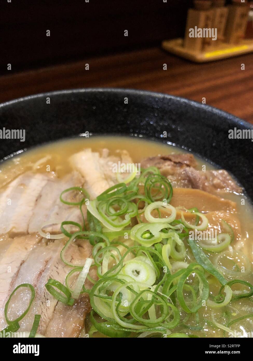 Close up of a bowl of ramen noodles soup with porc in a restaurant in Japan. - Smartphone Captured Stock Image