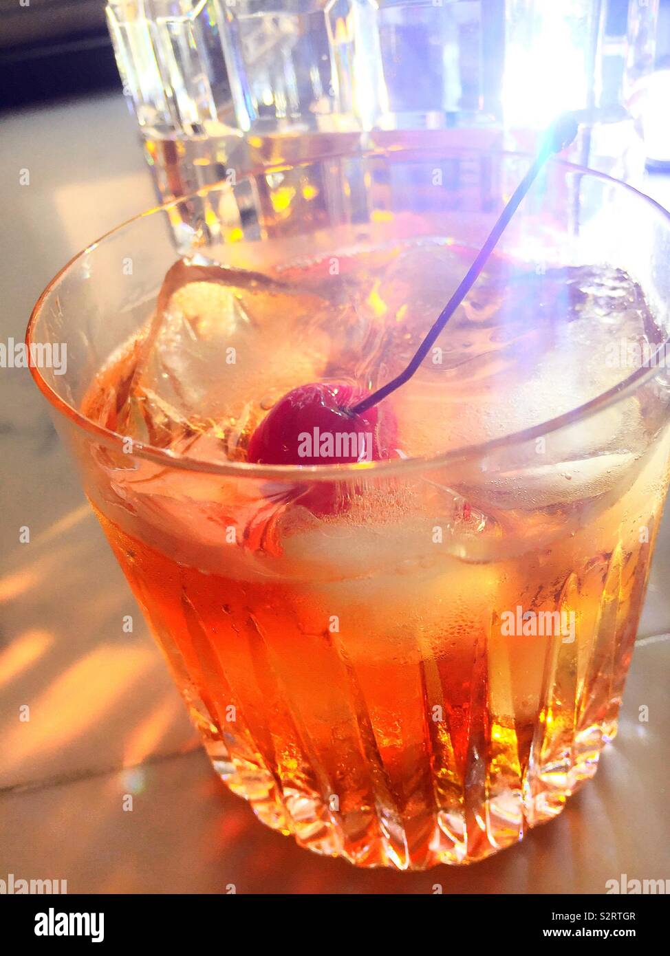 Close up of an old fashion bourbon cocktail in a crystal glass, USA - Smartphone Captured Stock Image