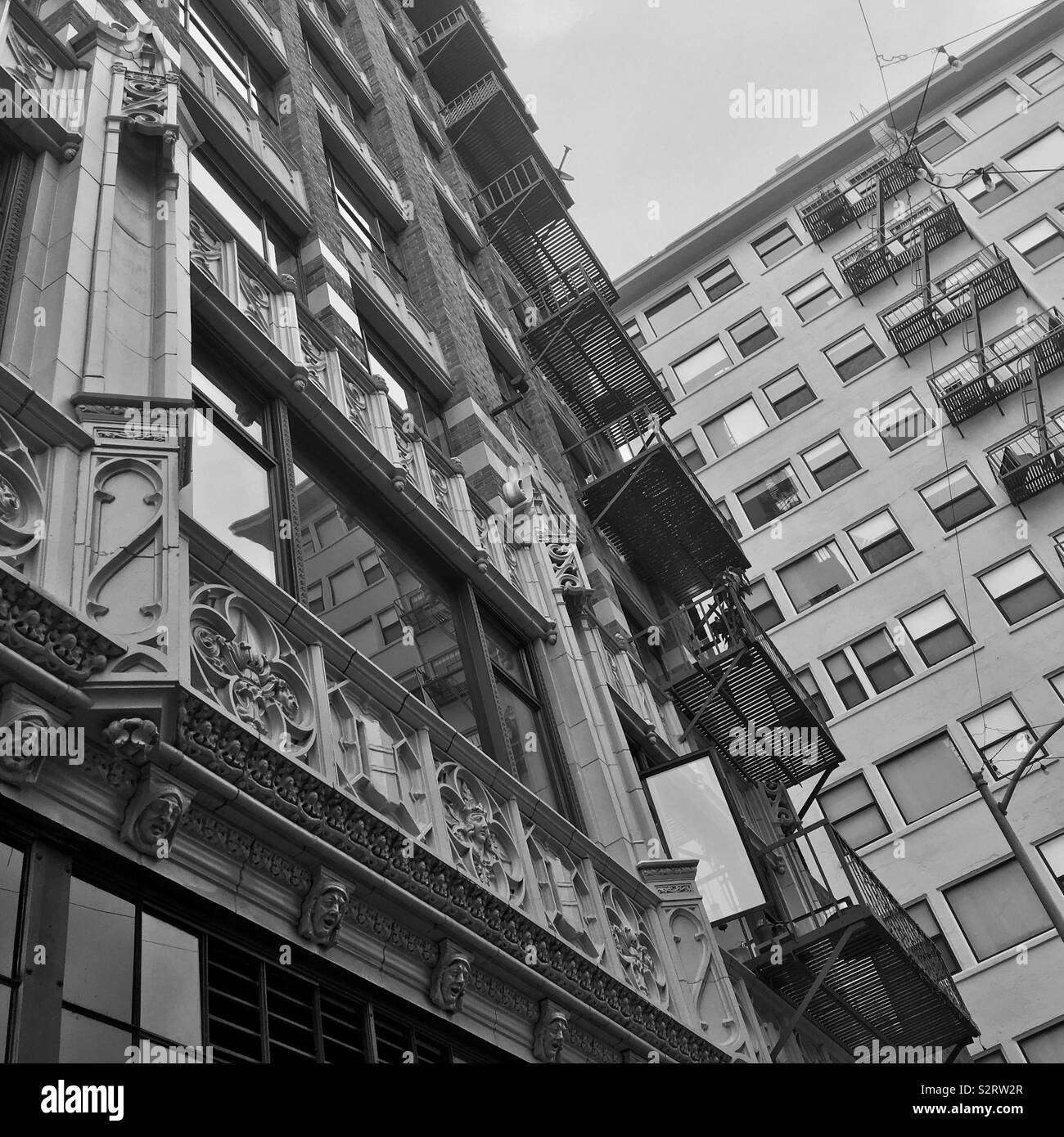 LOS ANGELES, CA, JUN 2019: apartment and office buildings in the Historic Core of Downtown, near Main Street. Black and white - Smartphone Captured Stock Image