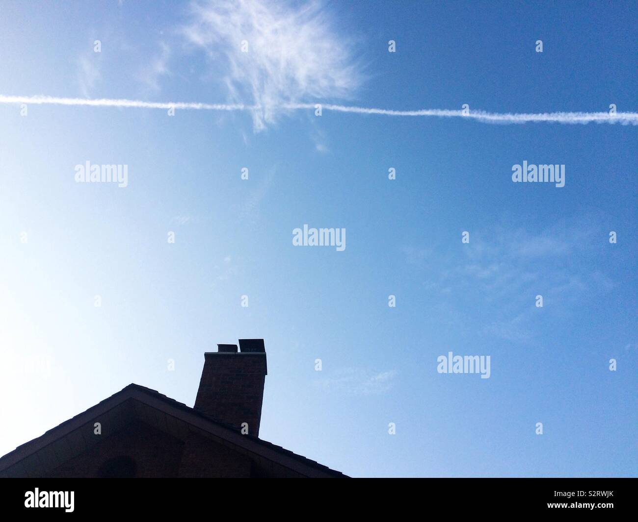 A jet fly over a house Stock Photo Alamy