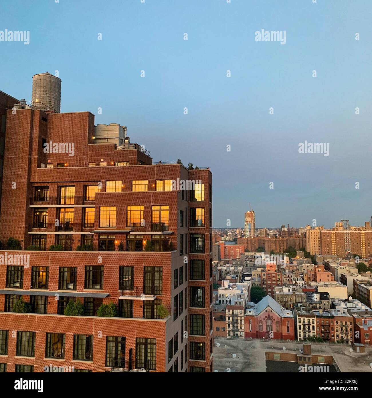 Sunset reflected in the windows of a Lower East Side building, New York City - Smartphone Captured Stock Image