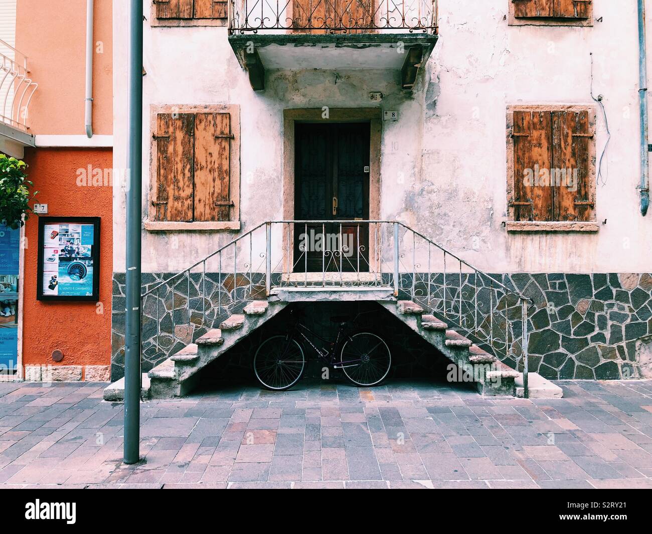 Bicycle under stairs in front of Italian building Stock Photo