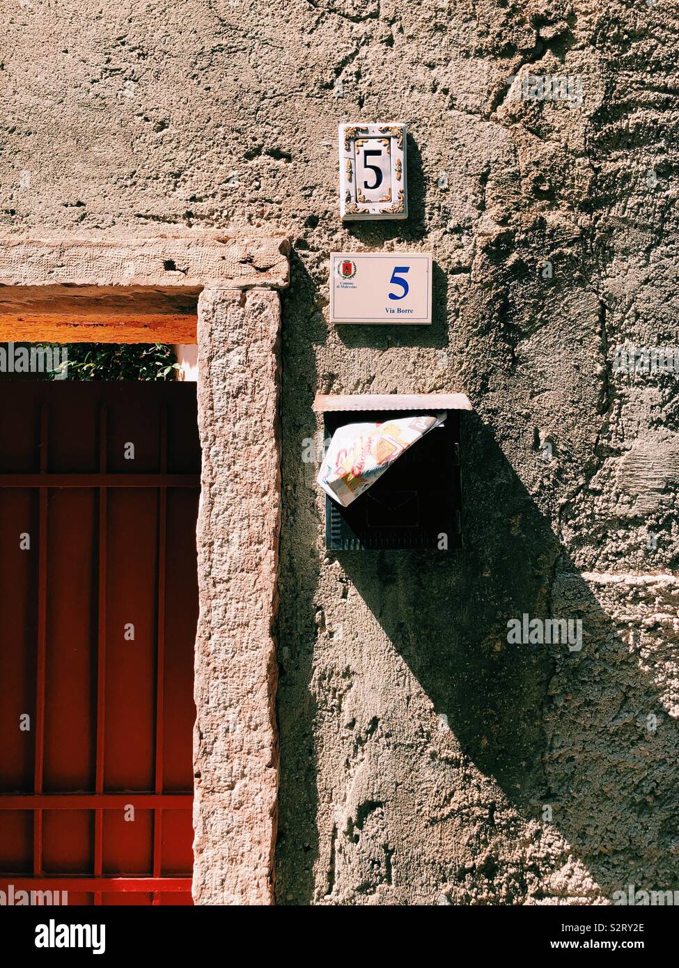 Wall in Italy with numbers and post box Stock Photo