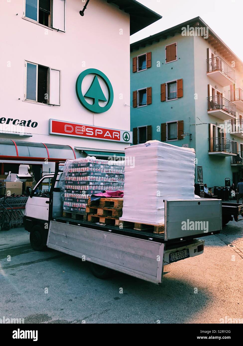 Heavily laden van outside Spar in Malcesine, Italy Stock Photo