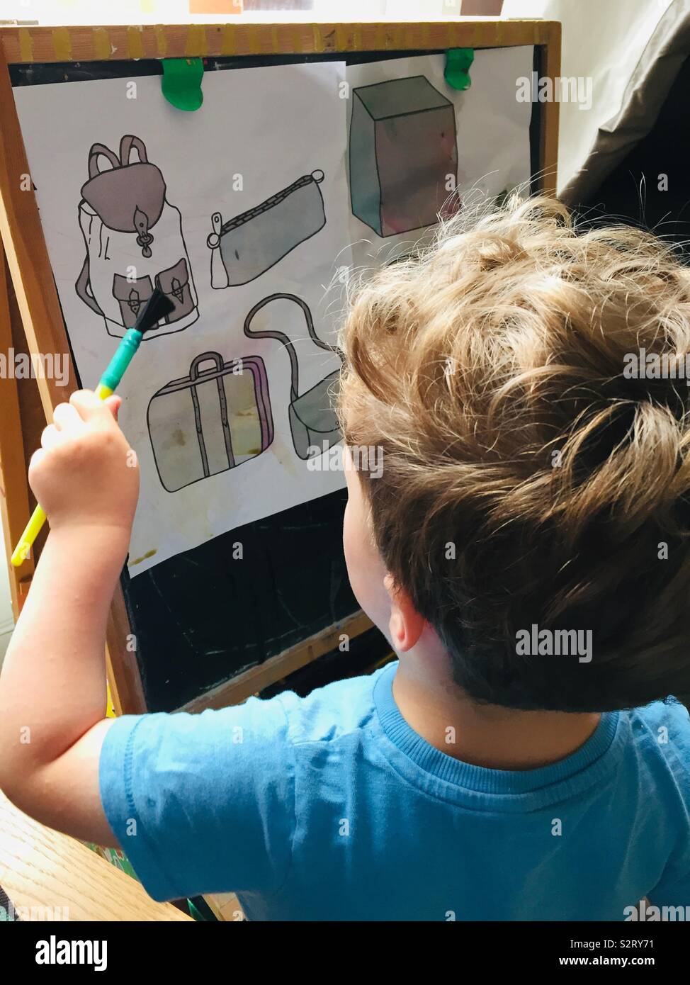 Toddler doing magic painting Stock Photo