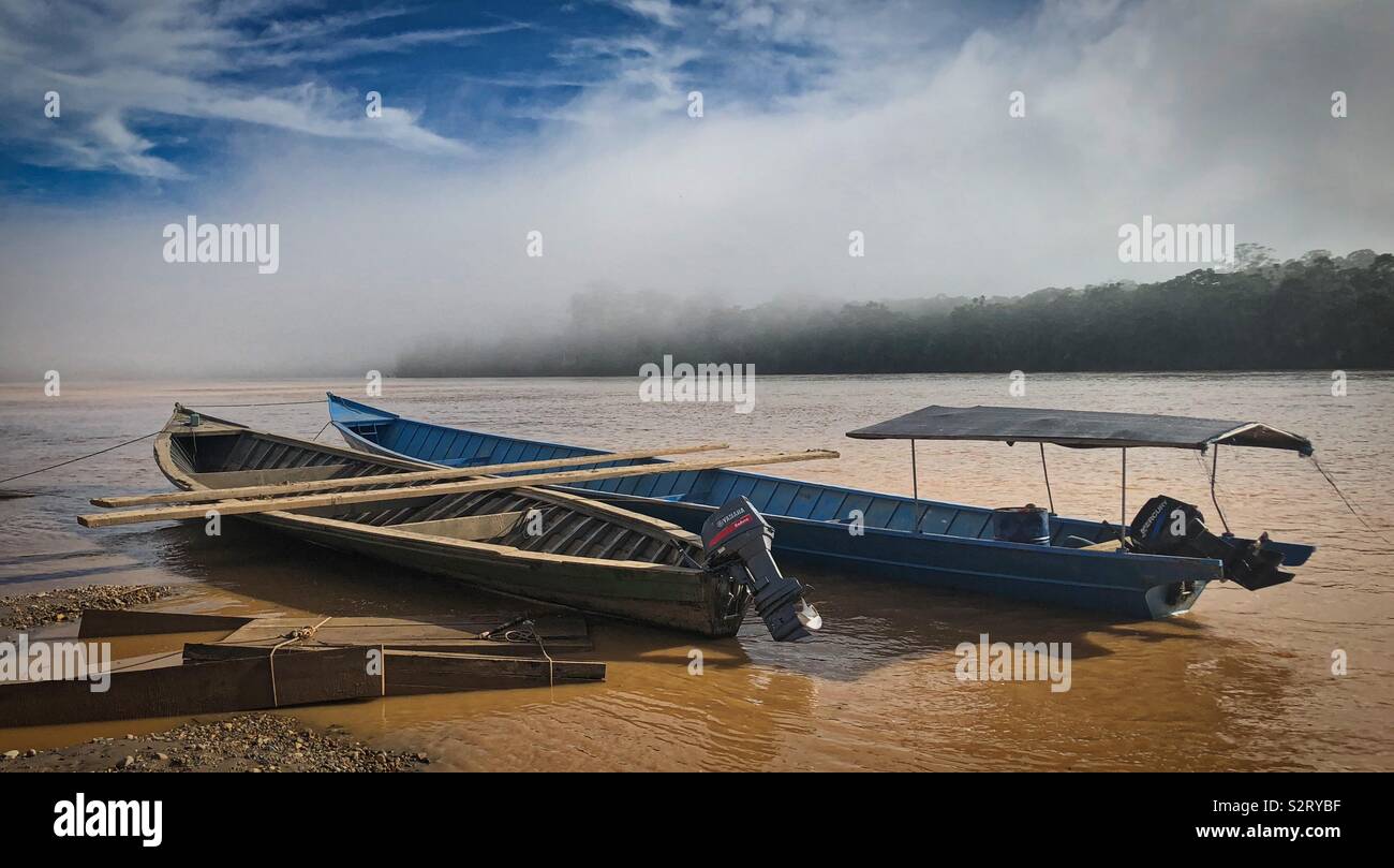 Two 2 empty boats moored on the Madre de Dios river, Manu, Peru Perú Peruvian Amazon Basin Amazonia - Smartphone Captured Stock Image