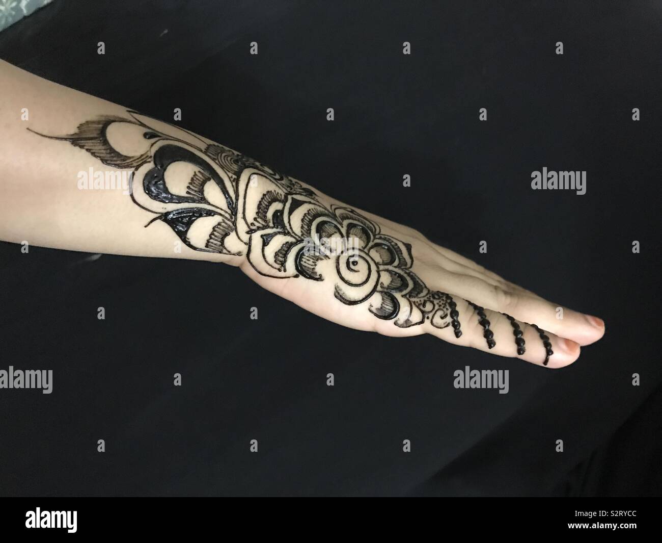 Pinter hand with black henna Stock Photo