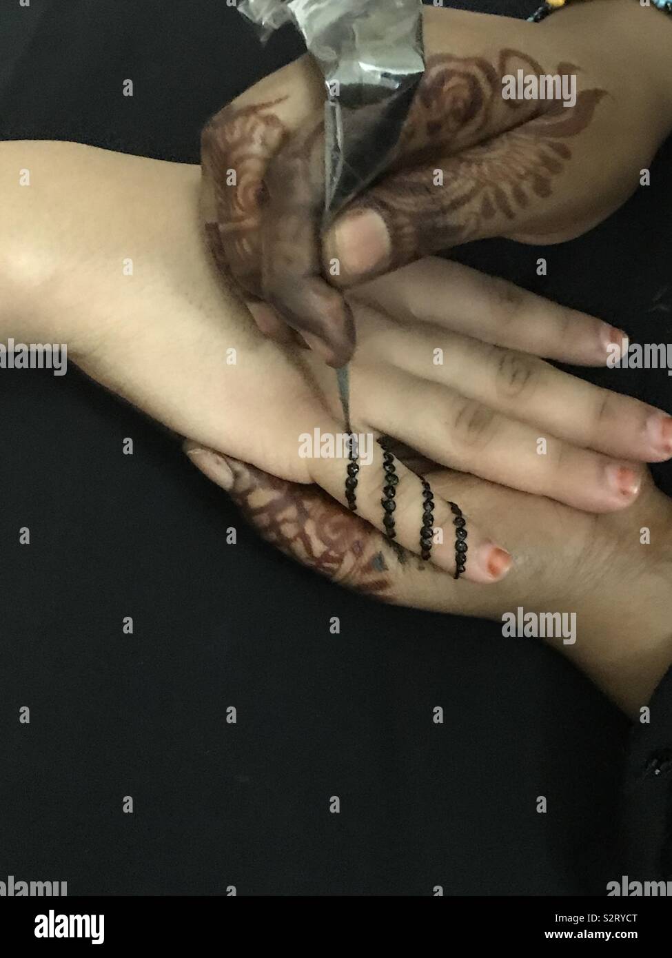 Henna painting with black dye (peacock) Stock Photo