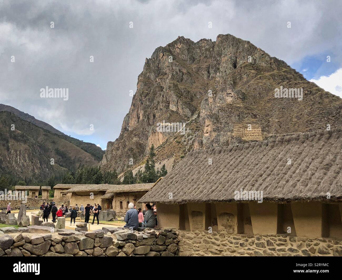 Tourists amongst ground level buildings at Incan ruins in Ollantaytambo, Perú Peru. - Smartphone Captured Stock Image