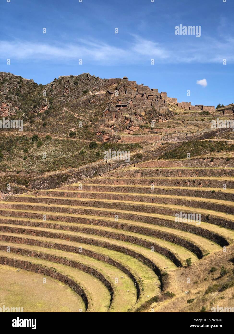 Agricultural terraces in front of the Incan ruins at Inca Pisac Písac Pisaq, Perú Peru. - Smartphone Captured Stock Image