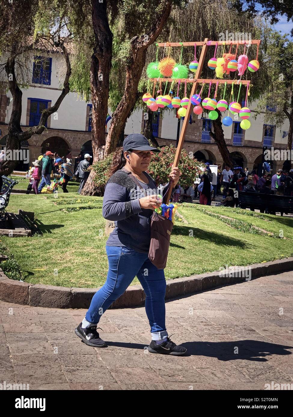 Peruvian woman selling colourful toys during the Inti Raymi or Inti Raymi’rata sun festival in Cusco Cuzco, Perú Peru. June 2019. - Smartphone Captured Stock Image