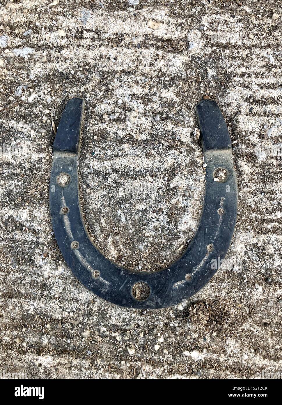 Horseshoe embedded in concrete Stock Photo Alamy