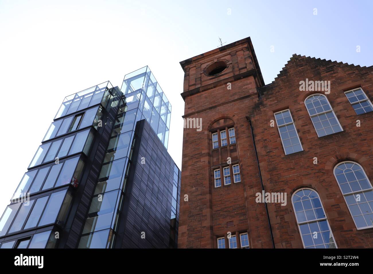 Abstract view of modern glass and traditional brick buildings Stock Photo