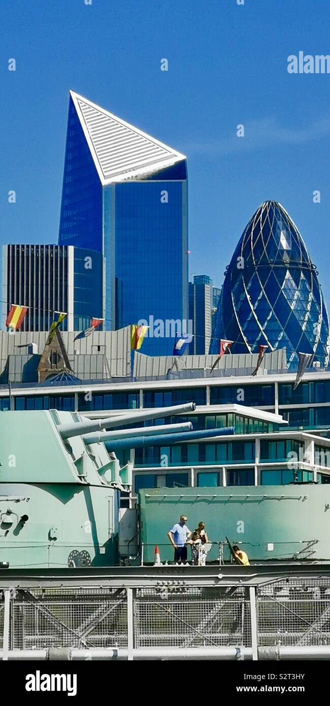 Skyscrapers in London seen through the HMS Belfast warship. - Smartphone Captured Stock Image