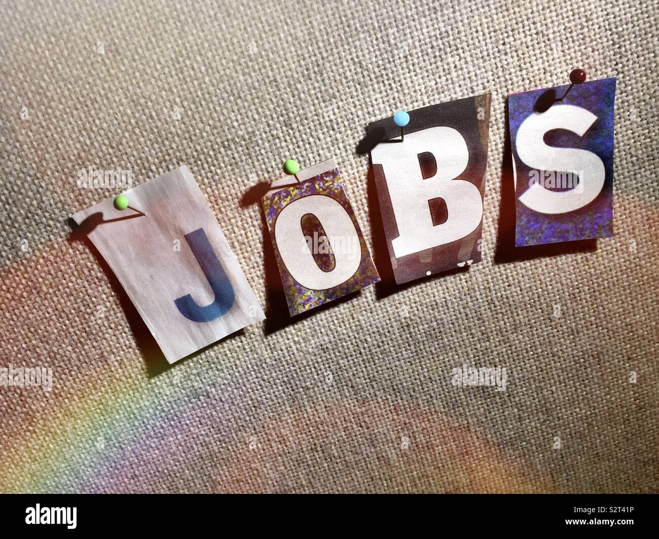 The word jobs on a bulletin board in the ransom note style typography, USA - Smartphone Captured Stock Image
