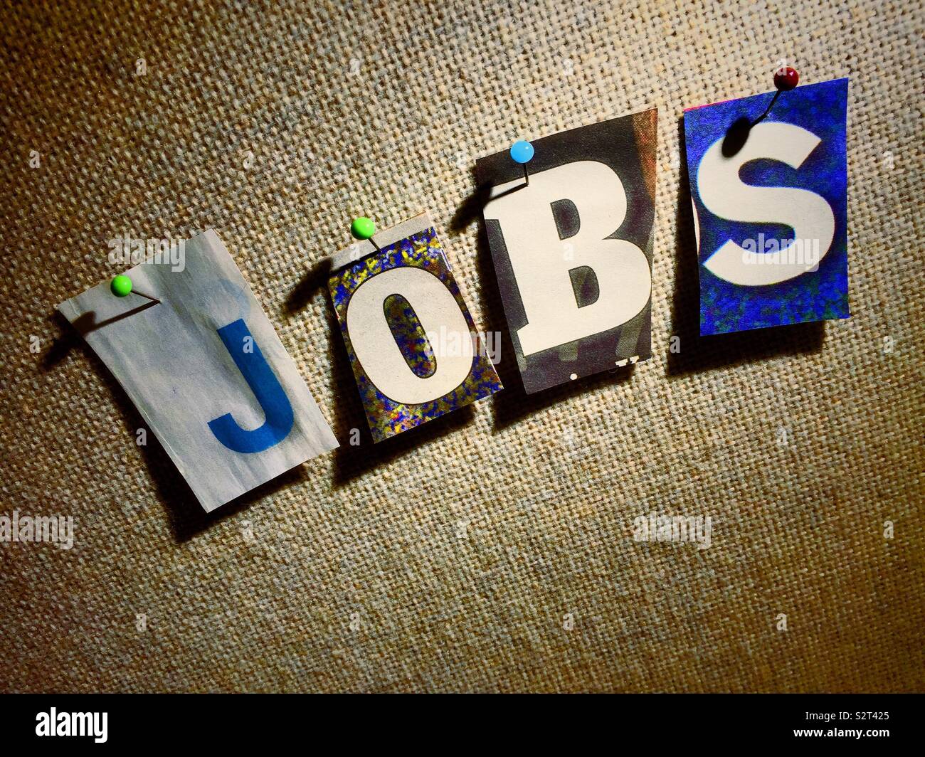 The word jobs on a bulletin board in the ransom note style topography, USA - Smartphone Captured Stock Image