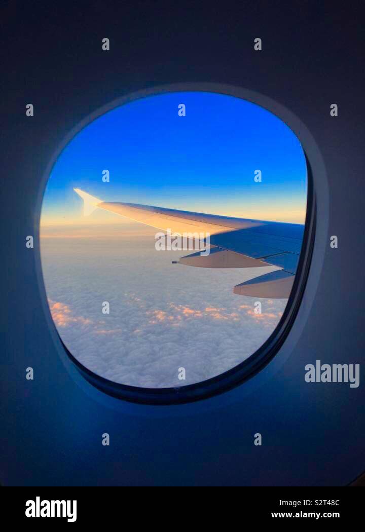 View out the window of an aeroplane at sunrise - Smartphone Captured Stock Image